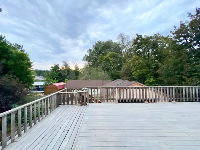 Expansive outdoor deck with wood railing, offering elevated outdoor space