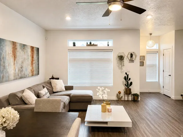 Spacious living area featuring wood-finish flooring, recessed lighting, and a ceiling fan