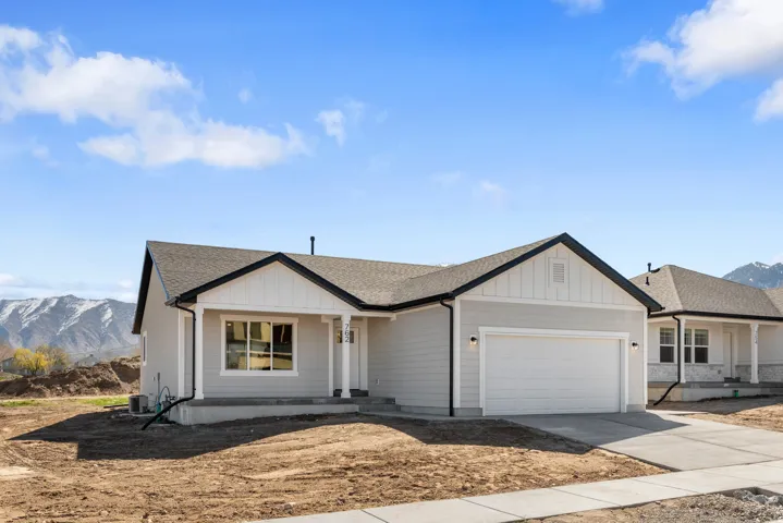 Modern ranch-style exterior with light gray siding and dark trim
