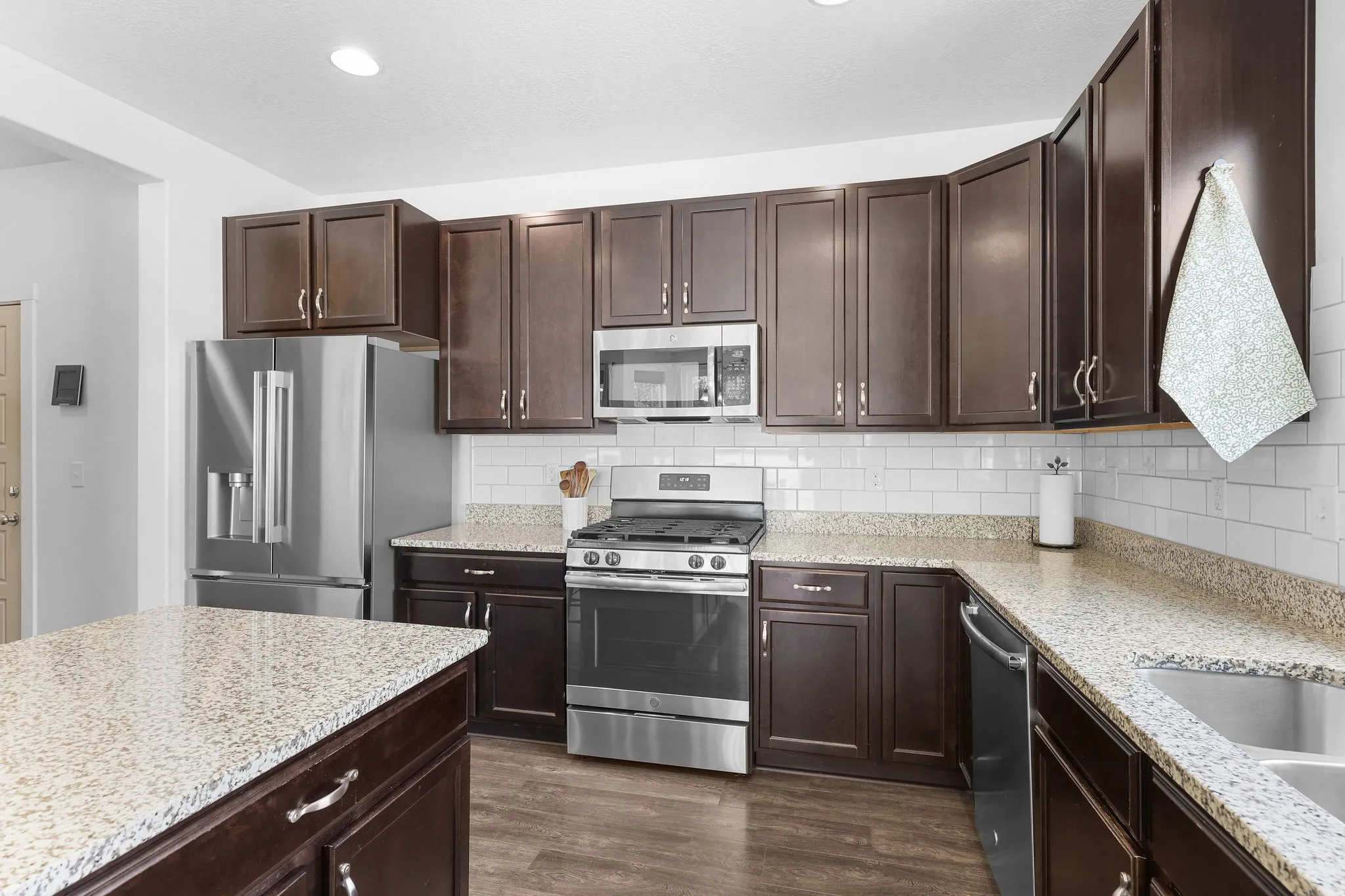 Dark wood-finish cabinetry with stainless steel hardware