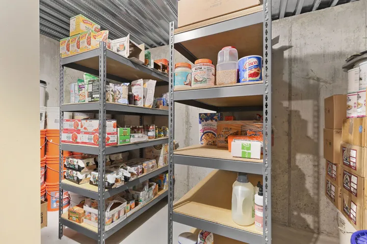 Open storage area featuring metal shelving units and exposed concrete walls