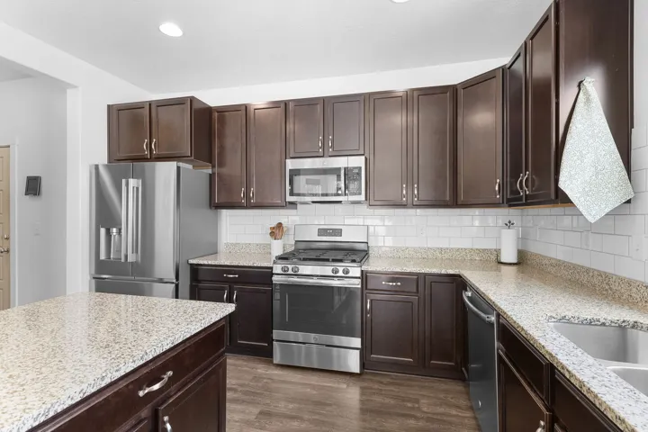 Dark wood-finish cabinetry with stainless steel hardware