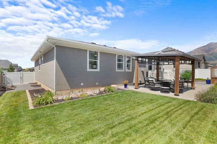 Expansive lawn with an integrated patio featuring a permanent gazebo