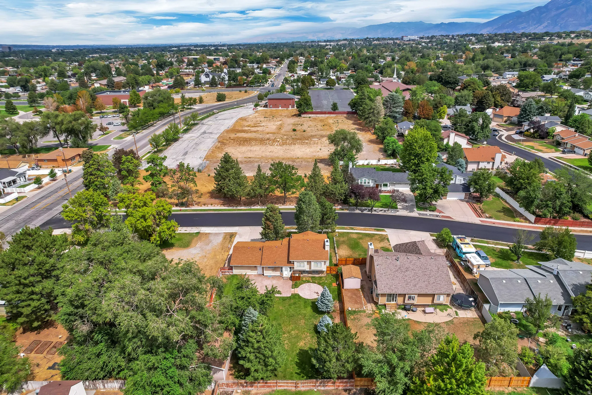 Established neighborhood setting with mature trees and mountain backdrop