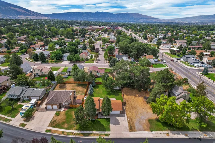 Expansive neighborhood with established trees and mountain backdrop