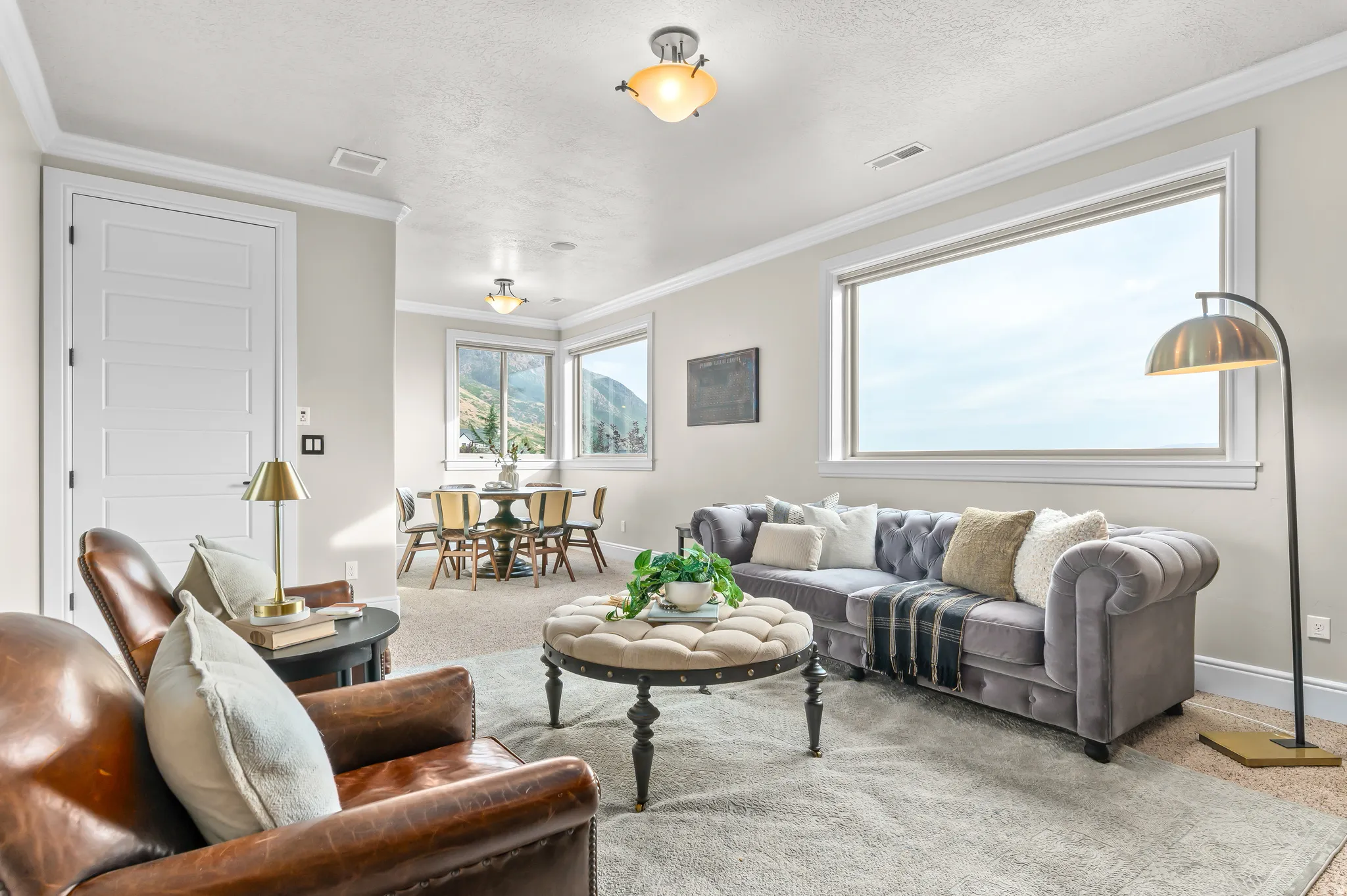 Spacious living area featuring ample natural light, crown molding, and recessed lighting