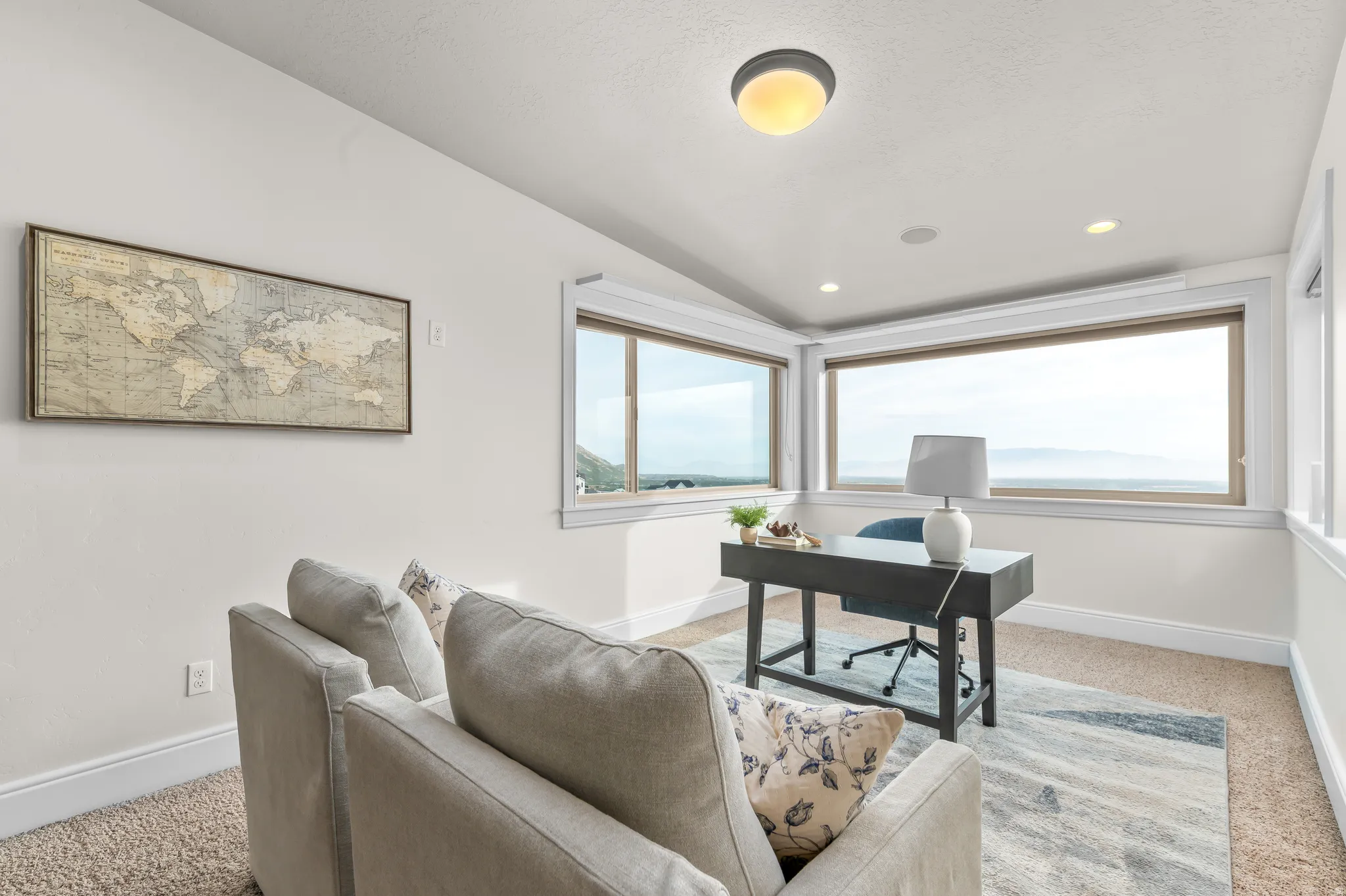 Recessed lighting, large windows, and wall-to-wall carpeting