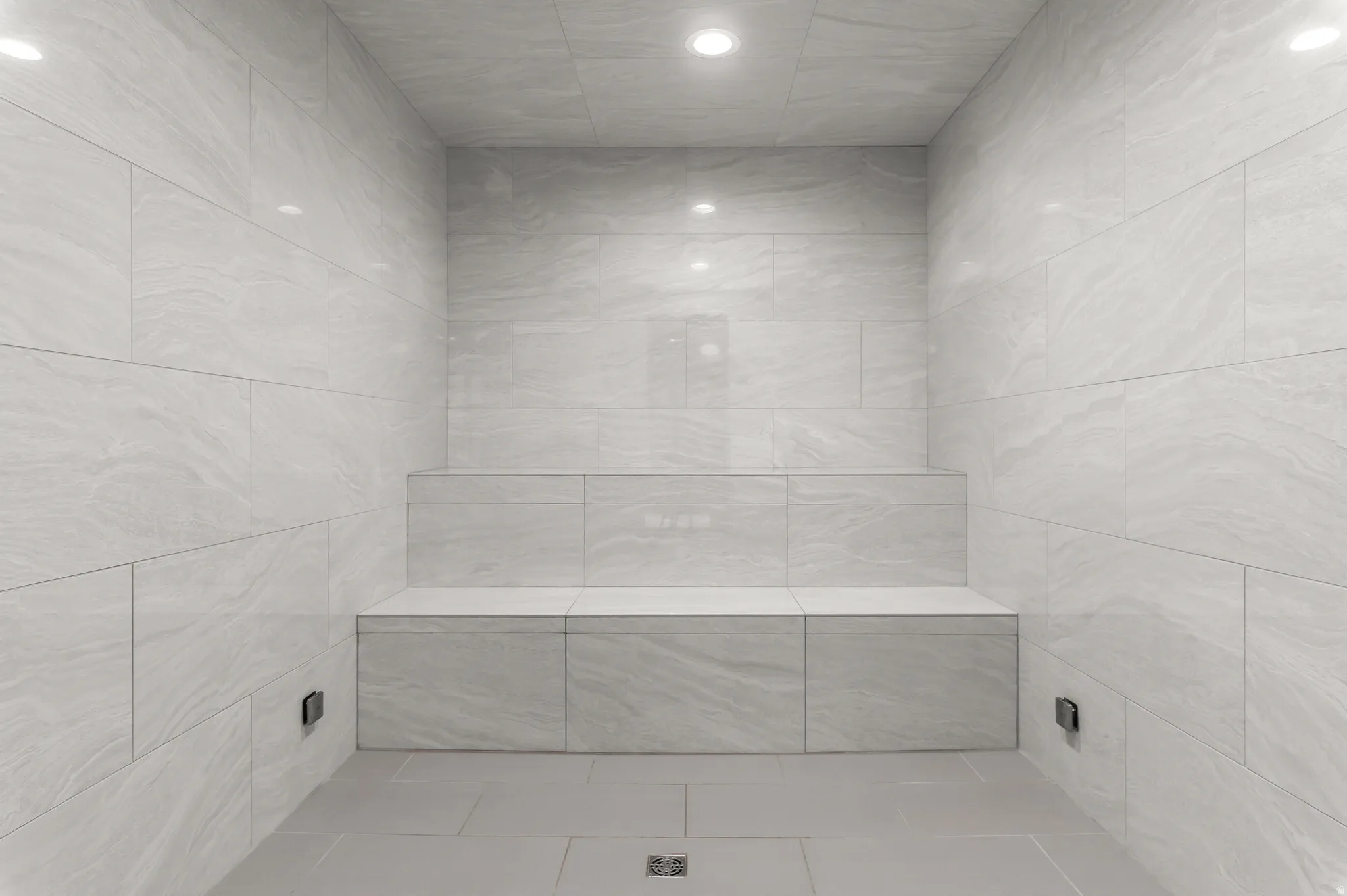 Tiled walls and flooring with a built-in bench