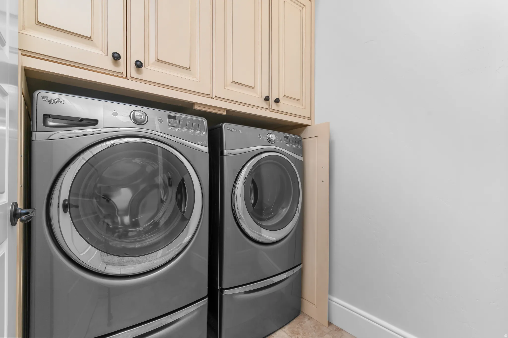 Upper cabinetry with dark hardware