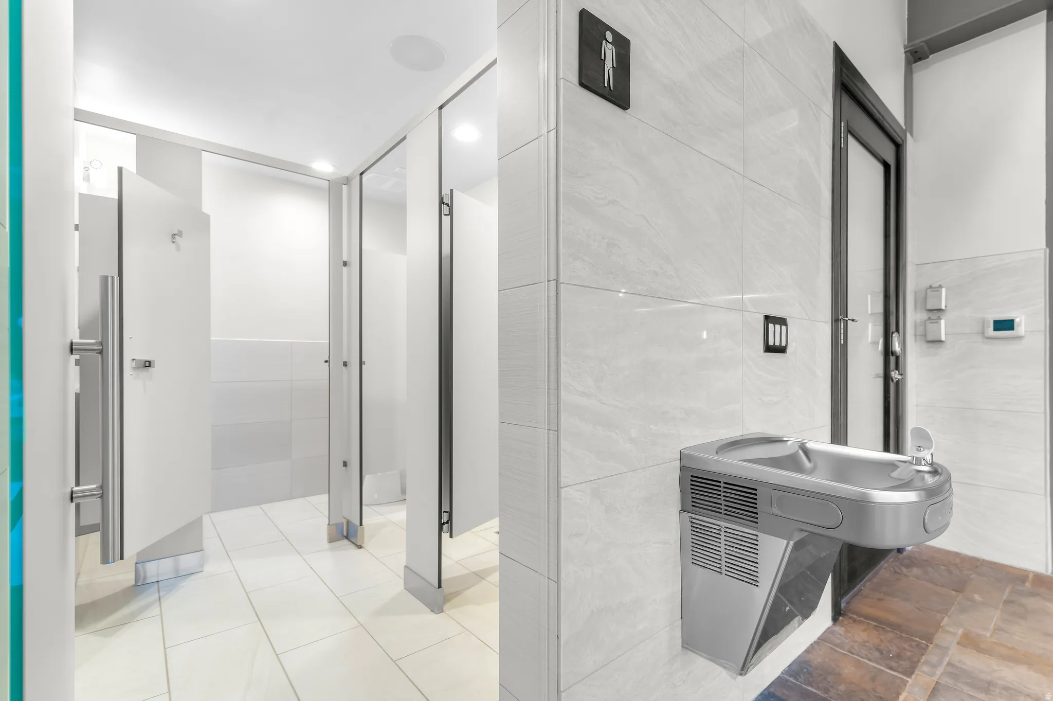 Wall-mounted drinking fountain with a stainless steel finish