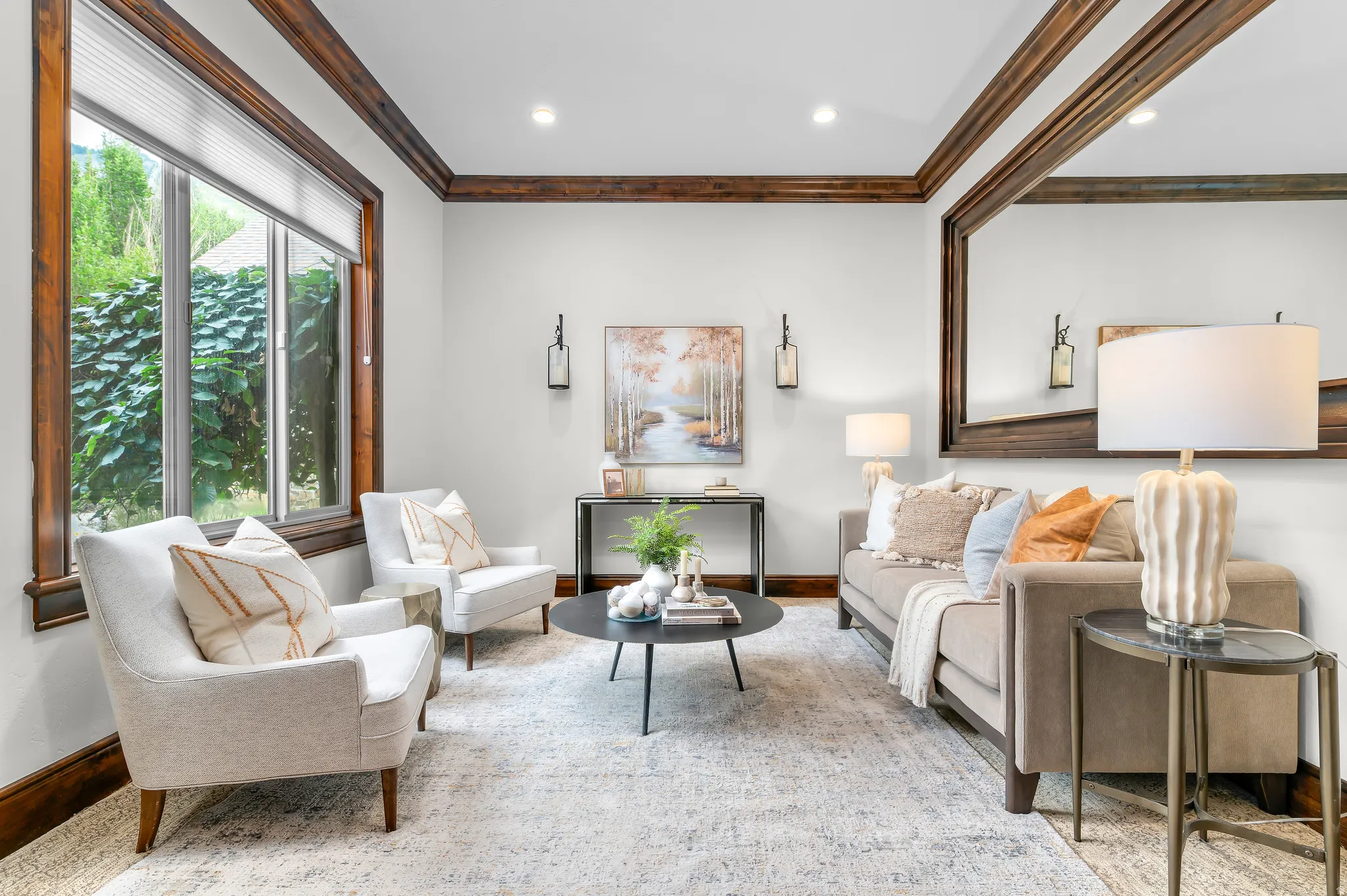 Recessed ceiling lights illuminate the room, highlighting the wood-framed window and coordinating decorative wall molding