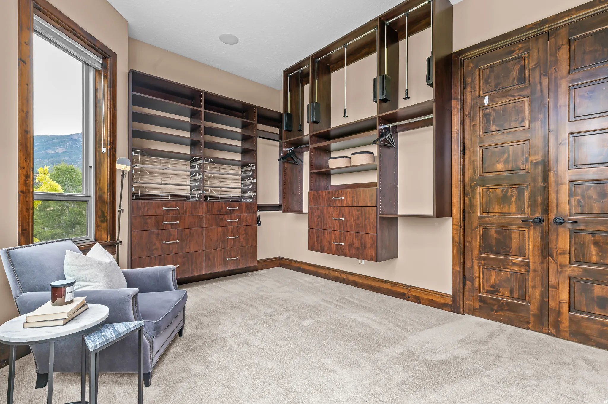 Custom built-in storage with drawers, open shelving, and hanging rods