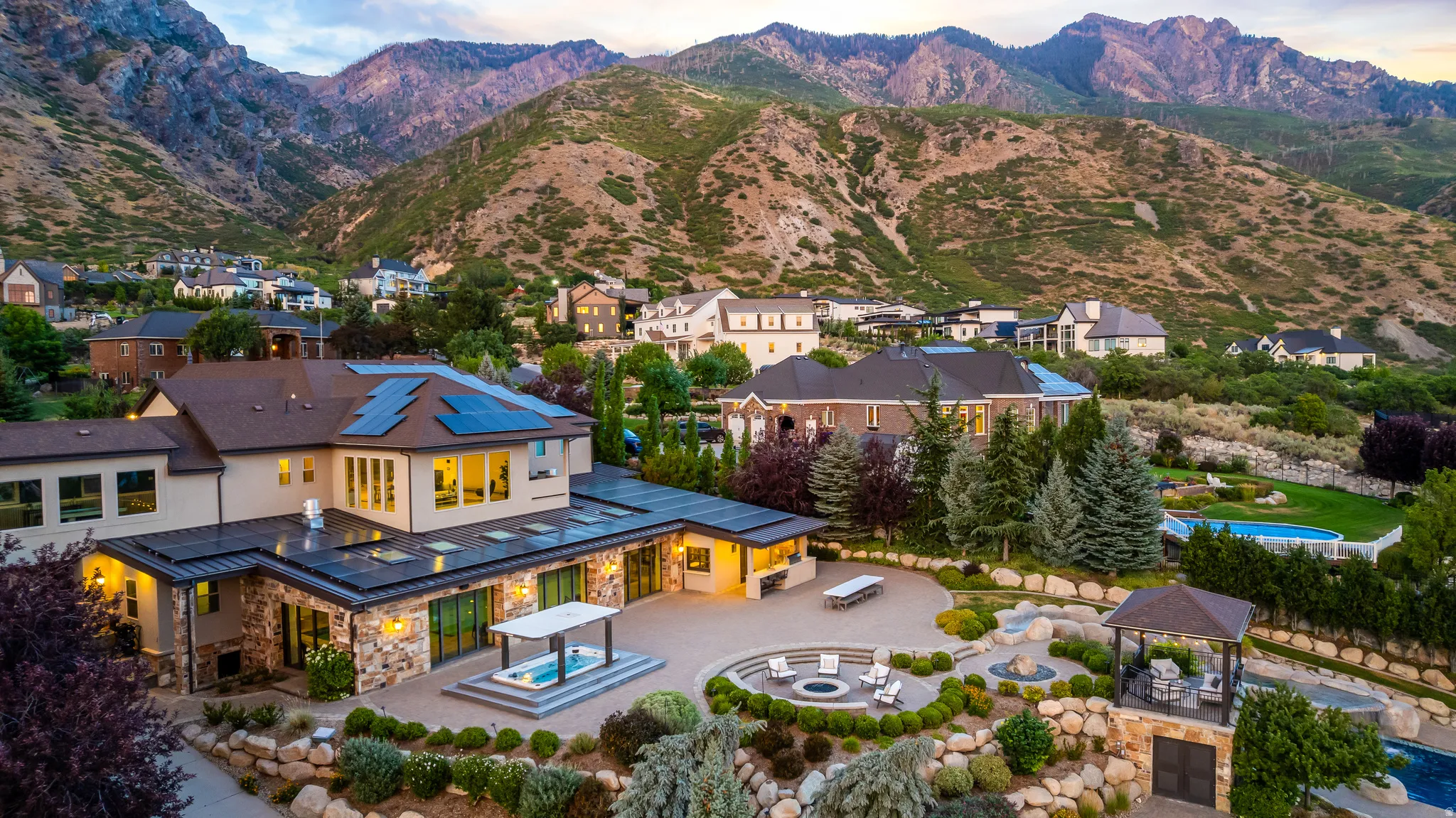Expansive outdoor living with fire pit, hot tub, swimming pool, and gazebo