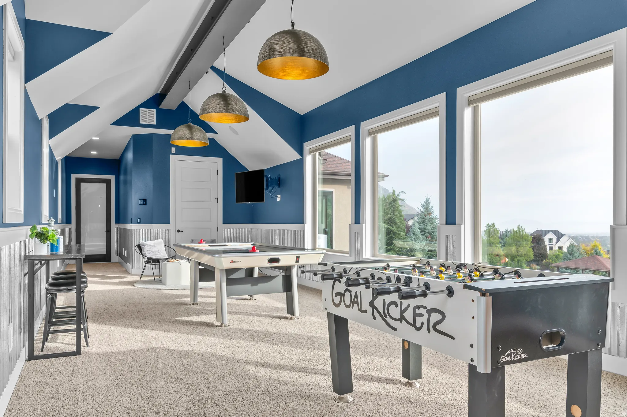 Expansive bonus room featuring multiple large windows, vaulted ceilings with accent beams, and recessed lighting
