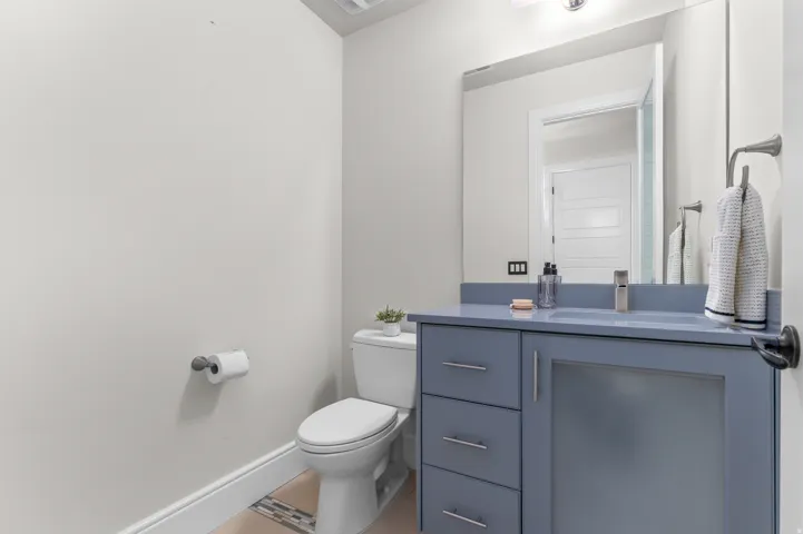 Vanity with a solid surface countertop, undermount sink, and contemporary faucet