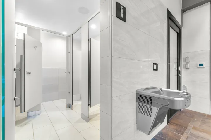 Wall-mounted drinking fountain with a stainless steel finish