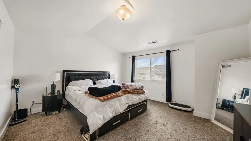 2nd Floor Master - Vaulted ceiling with an overhead light fixture, carpeted flooring, and a large window