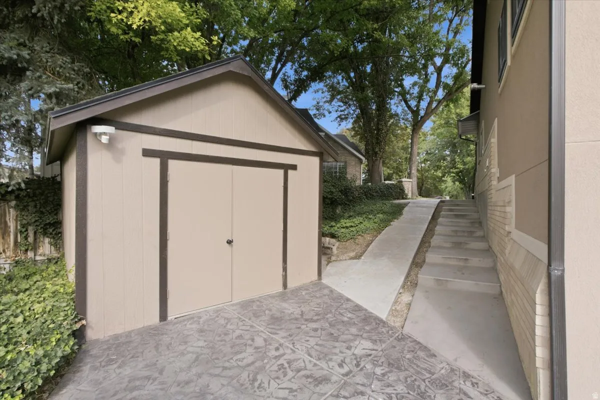 Stamped concrete pad with accessible pathway. Detached storage shed provides useful additional space for tools, equipment and outdoor gear.