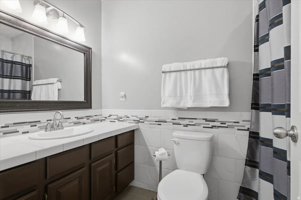 Dark wood-finish vanity with a white countertop and integrated sink