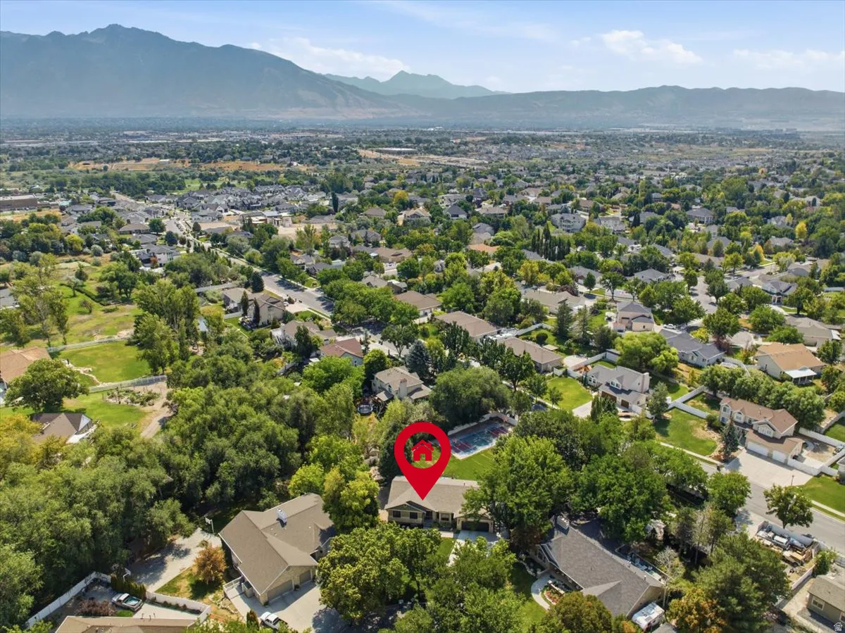Sweeping aerial captures beautiful mountain views surrounding the South Jordan setting. content