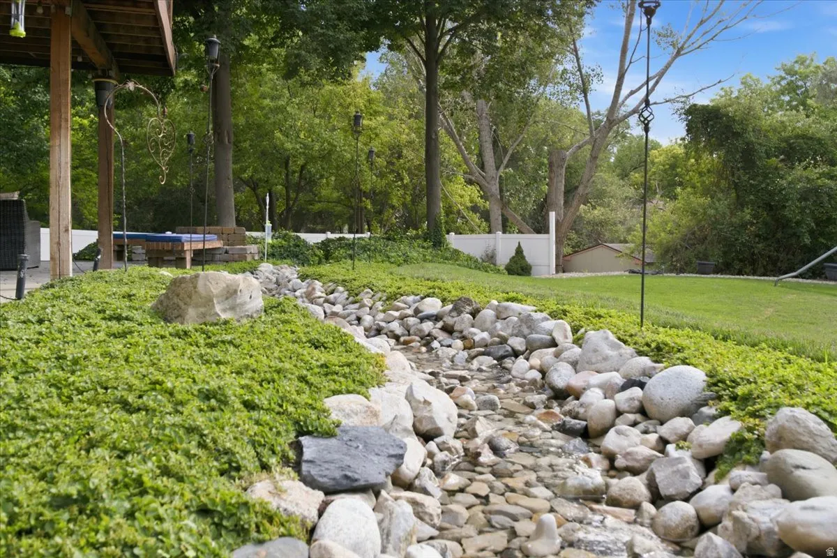 A recirculating stream winds through the mature landscaping, creating a truly distinctive backyard feature