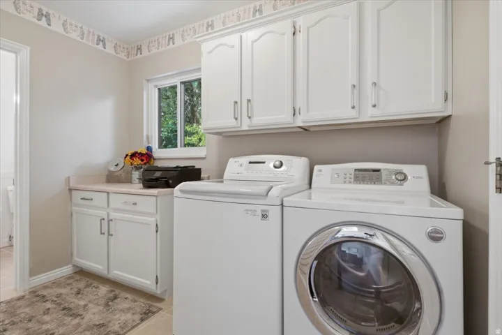 Convenient main-level laundry provides cabinetry, counter space and natural light.