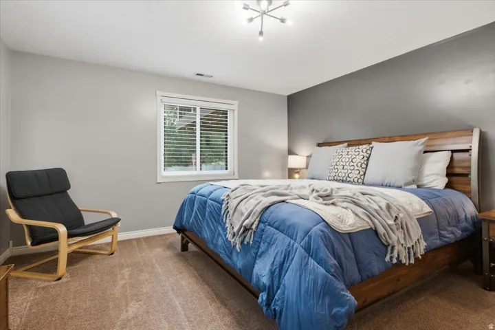 Comfortable bedroom with neutral finishes and excellent natural light.