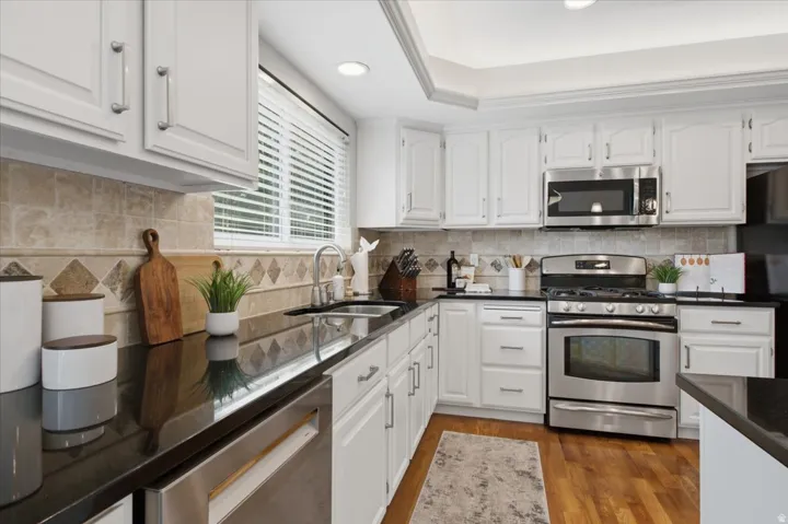 Bright kitchen features generous counter space, stainless appliances and convenient workspace.