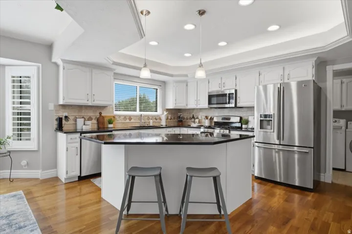 Spacious kitchen with generous island seating, stainless appliances and abundant cabinetry.