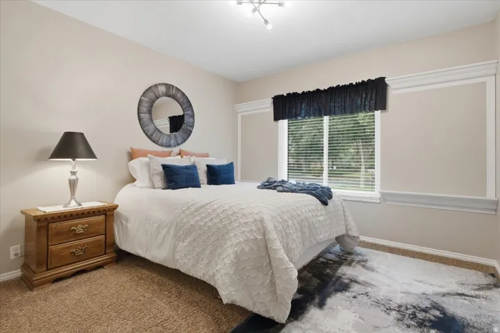 Generously sized secondary bedroom with a large window and flexible furniture arrangement