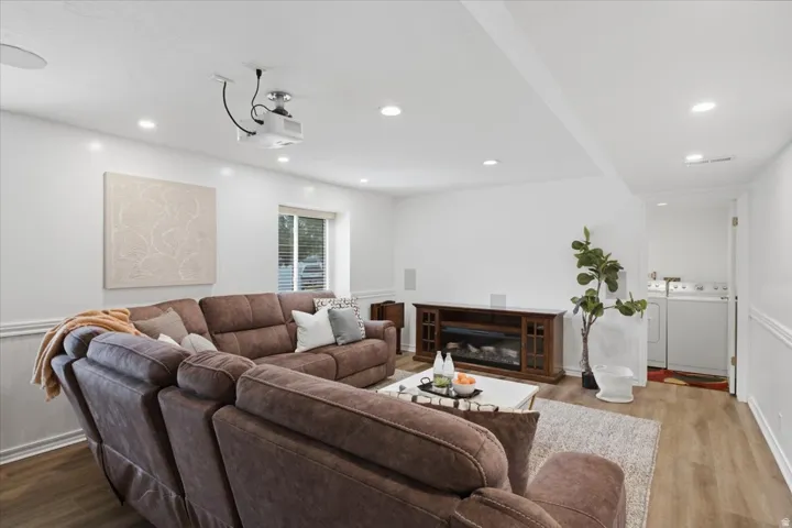 Newly renovated lower-level living area is configured for movie nights with a projector and spacious seating area.