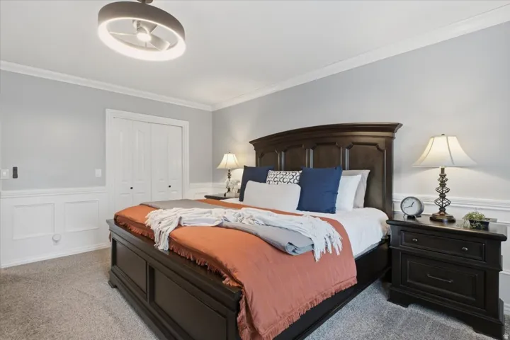 Spacious primary suite with beautiful plantation shutters, a window seat and an inviting retreat-like feel.