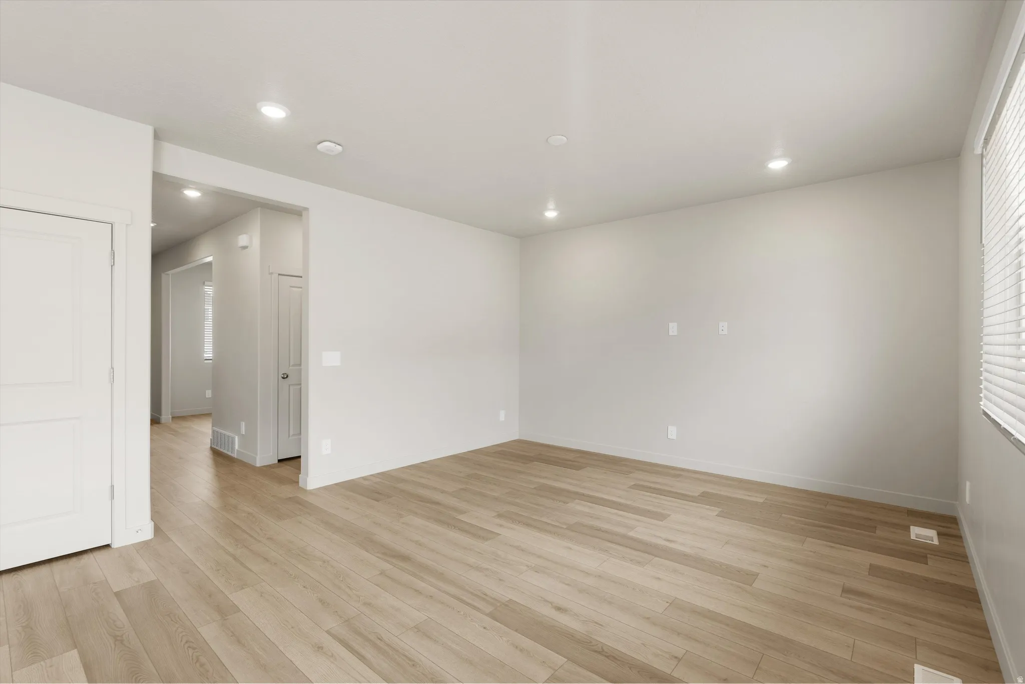 **DISCLAIMER** This floorplan has upgrades not photographed.Recessed lighting, wood-finish flooring, light-toned wall paint, white trim, and window blinds