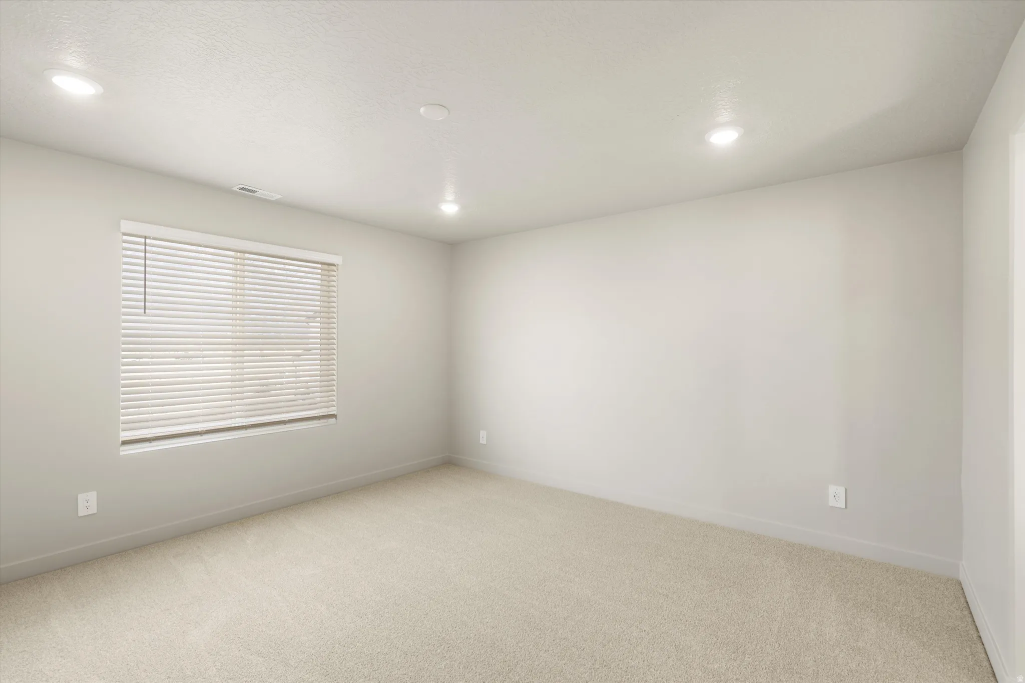 **DISCLAIMER** This floorplan has upgrades not photographed.Recessed lighting, wall-to-wall carpeting, window with horizontal blinds, and neutral wall tones