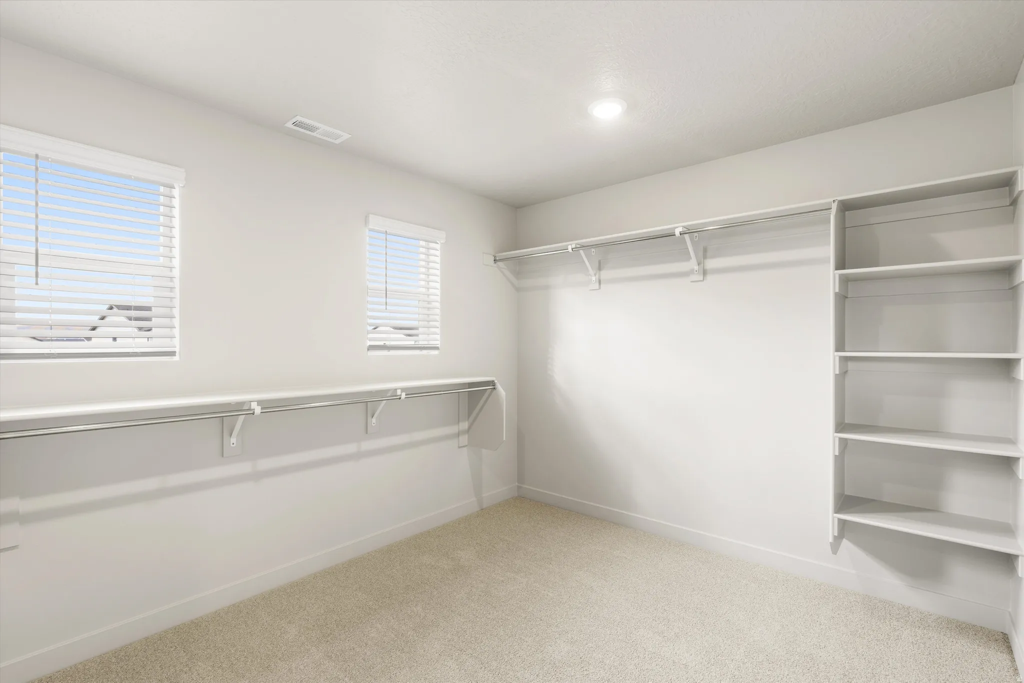**DISCLAIMER** This floorplan has upgrades not photographed.Recessed lighting, wall-mounted shelving, built-in clothing rods, and two windows with blinds