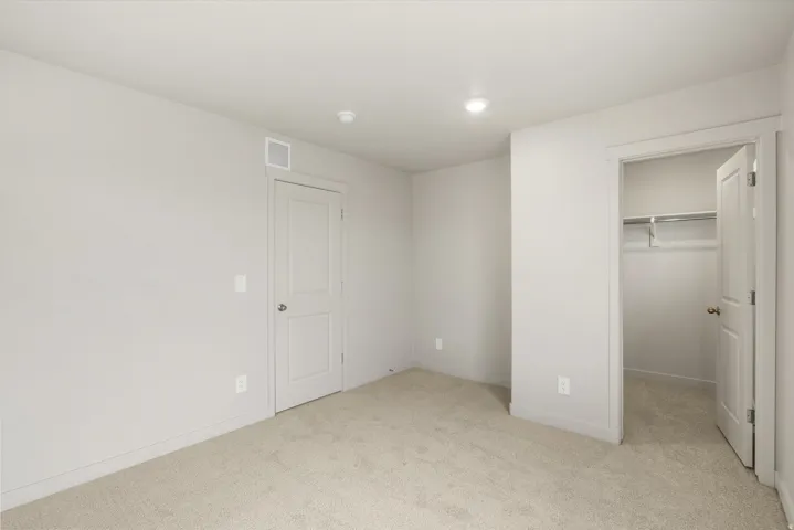 **DISCLAIMER** This floorplan has upgrades not photographed.Plush carpet flooring, recessed ceiling lighting, light-colored walls, and a built-in closet with shelving