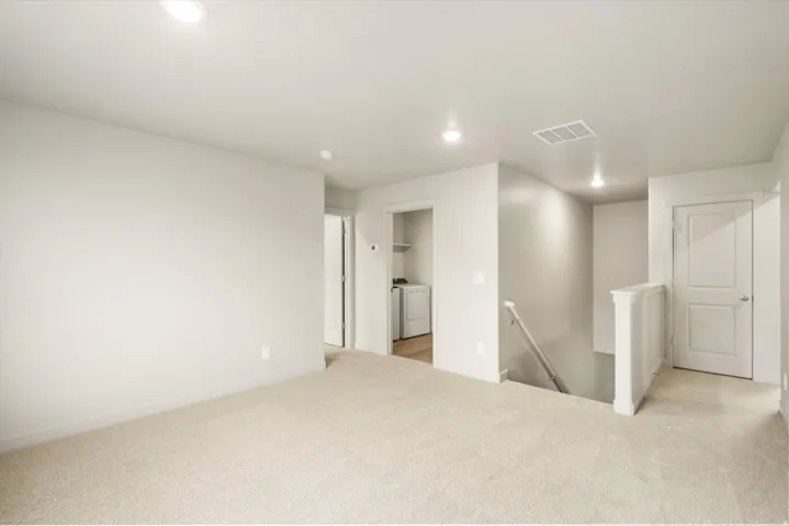 **DISCLAIMER** This floorplan has upgrades not photographed.Carpeted landing area featuring recessed lighting, a laundry alcove with built-in shelving, and a paneled door