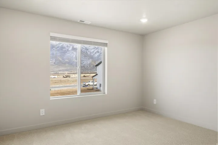 **DISCLAIMER** This floorplan has upgrades not photographed.Recessed ceiling lighting, neutral carpet, light-toned walls, and a large window with horizontal blinds
