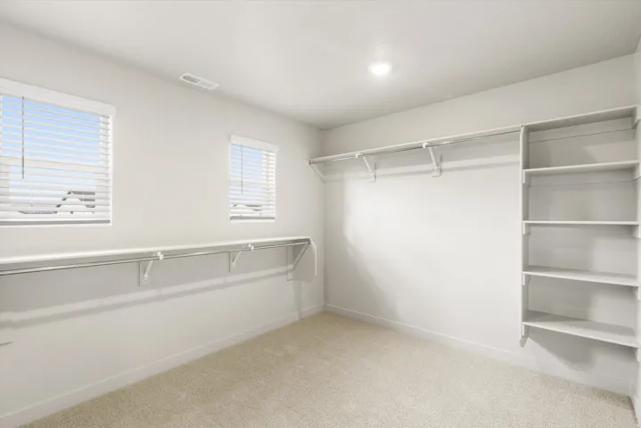 **DISCLAIMER** This floorplan has upgrades not photographed.Recessed lighting, wall-mounted shelving, built-in clothing rods, and two windows with blinds