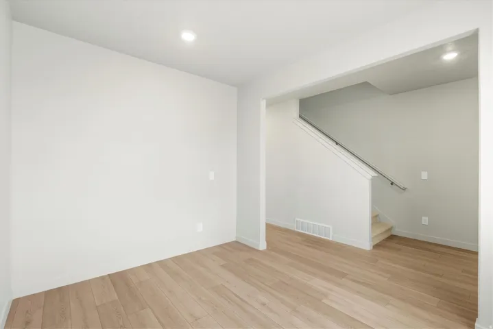 **DISCLAIMER** This floorplan has upgrades not photographed.Recessed lighting, light wood-finish flooring, staircase with carpeted treads, and a metal handrail
