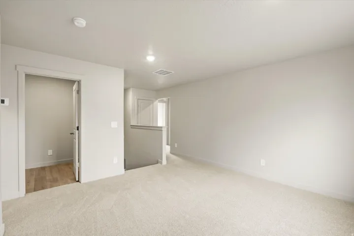 **DISCLAIMER** This floorplan has upgrades not photographed.Neutral-toned carpeting, recessed ceiling lighting, and a white interior door