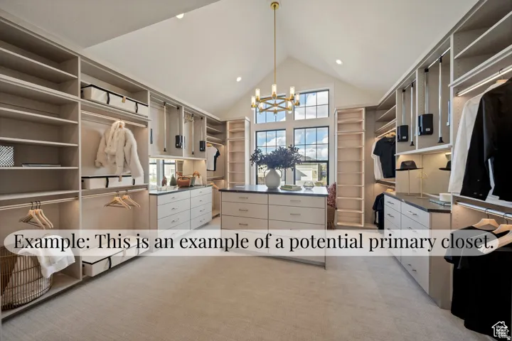Expansive closet featuring extensive built-in shelving, hanging rods, and drawer storage, with a central island offering additional storage and counter space