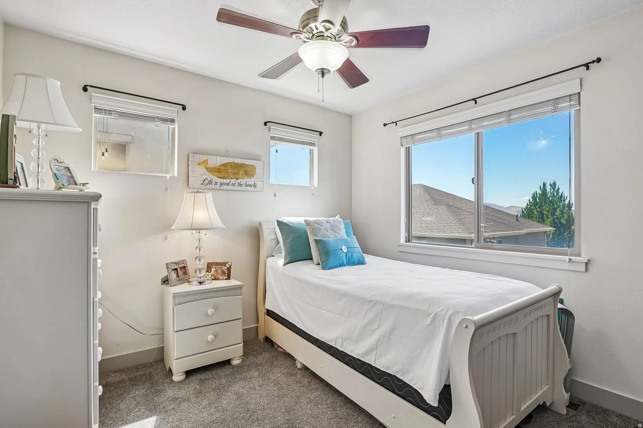 Recessed window, ceiling fan, carpet flooring, crown molding, and white wall paint