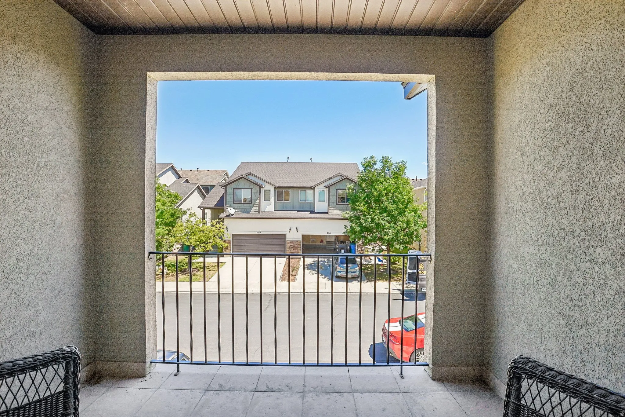 Balcony with a black metal railing and light-colored tile flooring