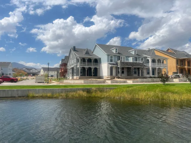 Waterfront property with a concrete retaining wall and manicured grass area