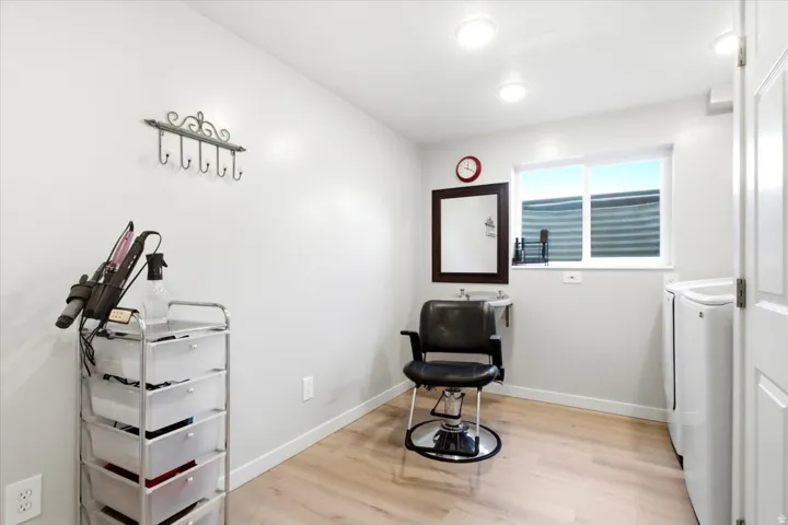 Recessed lighting, wood-finish flooring, and a window provide illumination