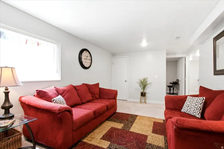 Carpeted flooring, white interior walls, recessed lighting, white trim, and a horizontal window