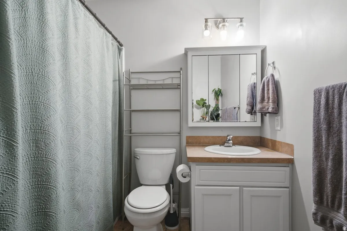 Vanity with an integrated sink, tri-panel mirrored medicine cabinet, and a three-light fixture