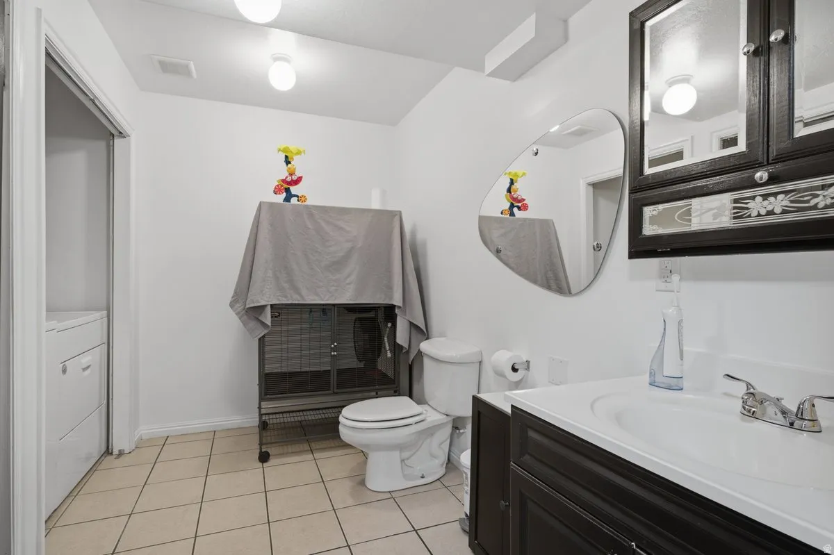 White walls with ceiling-mounted fixtures and light tile flooring