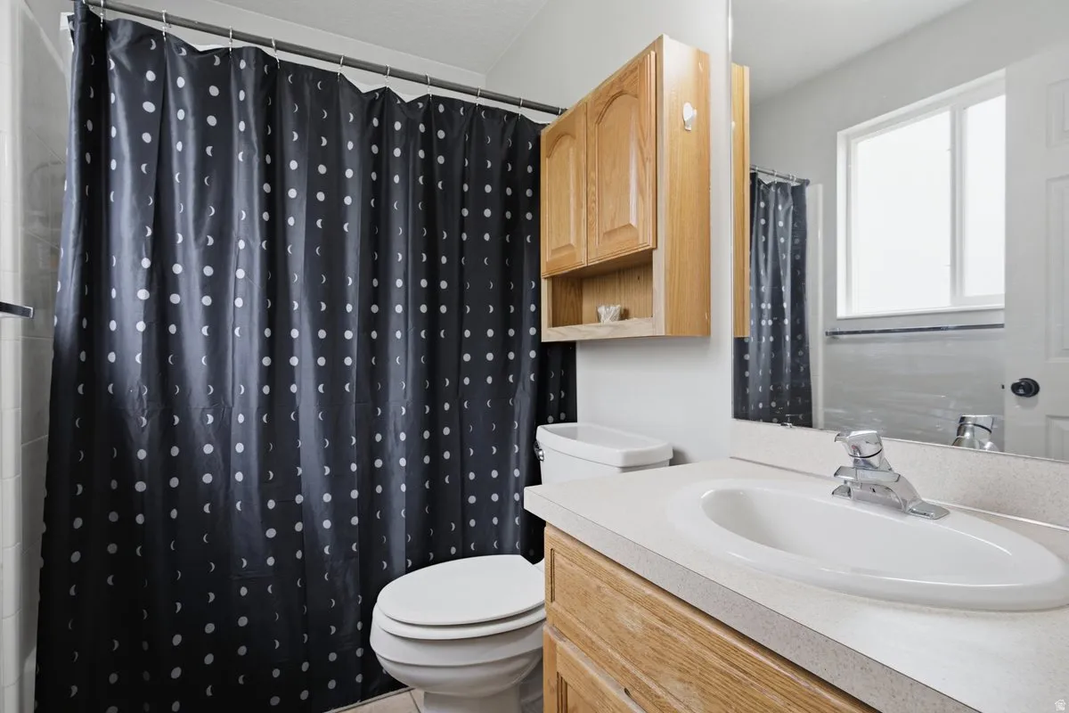 Vanity with an integrated sink and chrome faucet, wood-finish cabinetry, and an overhead medicine cabinet